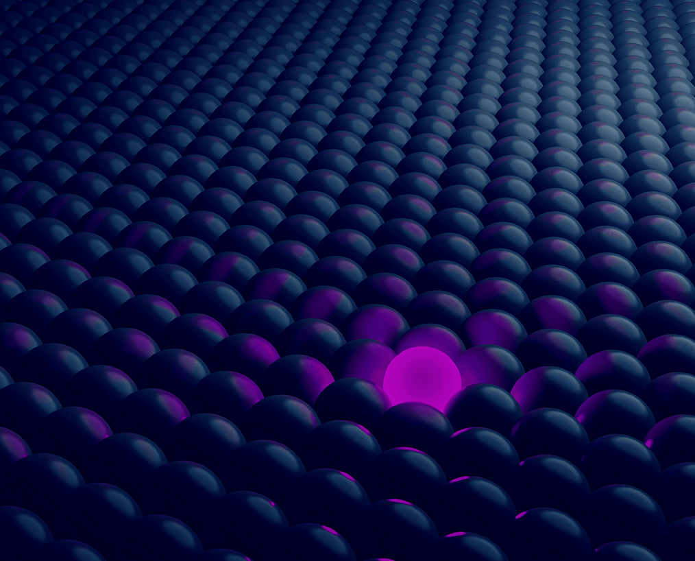 a purple ball in a group of black balls